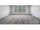 Spacious bedroom with wall-to-wall carpeting and large windows at 6848 Good News Dr, Charlotte, NC 28215