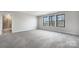 Bright bedroom featuring carpet, large windows, and ensuite bathroom at 6848 Good News Dr, Charlotte, NC 28215