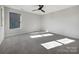 Simple bedroom with gray carpeting and plenty of natural light at 6848 Good News Dr, Charlotte, NC 28215