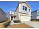 Two-story house with light beige vinyl siding, a two-car garage, and landscaping at 6848 Good News Dr, Charlotte, NC 28215