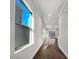 Bright hallway with hardwood floors and large windows offering natural light at 6848 Good News Dr, Charlotte, NC 28215
