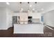 Modern kitchen with white cabinets, grey countertops and island at 6848 Good News Dr, Charlotte, NC 28215