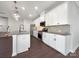 Modern kitchen with white cabinets, gray countertops, and stainless steel appliances at 6848 Good News Dr, Charlotte, NC 28215