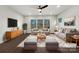 Virtually staged living room featuring a neutral color palette and modern furniture at 6848 Good News Dr, Charlotte, NC 28215