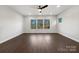 Spacious living room with dark brown wood-look flooring and large windows at 6848 Good News Dr, Charlotte, NC 28215