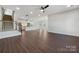 Open living room showcasing hardwood floors and kitchen view at 6848 Good News Dr, Charlotte, NC 28215