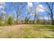 Large backyard with mature trees and wooden fence at 804 Rayon St, Charlotte, NC 28216