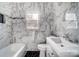 Clean bathroom with marble tile and a bathtub at 804 Rayon St, Charlotte, NC 28216