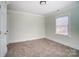 Neutral-toned bedroom with carpet and window at 804 Rayon St, Charlotte, NC 28216