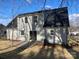 Rear view of the house showcasing a patio and fenced backyard at 8506 Milton Morris Dr, Charlotte, NC 28227