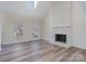 Spacious living room featuring a white brick fireplace and hardwood floors at 8506 Milton Morris Dr, Charlotte, NC 28227