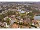 Aerial view showing community pool, tennis courts, pond at 8514 Ulster Ct, Indian Land, SC 29707