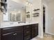 Contemporary bathroom featuring double sinks, a large mirror, and stylish dark wood vanity at 857 Spelman Dr, Indian Land, SC 29707