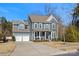 Two-story house with gray siding, a two-car garage, and a landscaped front yard at 857 Spelman Dr, Indian Land, SC 29707
