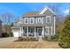Two-story house with gray siding, a front porch, and a landscaped yard at 857 Spelman Dr, Indian Land, SC 29707