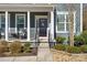 Front door entrance with columns, a porch, and well-manicured landscaping at 857 Spelman Dr, Indian Land, SC 29707
