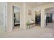 Hallway with doors to a bedroom and laundry room, a wooden bench with decorative plant at 857 Spelman Dr, Indian Land, SC 29707