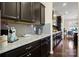Well-lit kitchen features granite countertops, gray subway tile backsplash, and sleek dark cabinets with contemporary hardware at 857 Spelman Dr, Indian Land, SC 29707