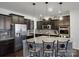 Modern kitchen with granite countertops, stainless steel appliances, dark cabinets, and pendant lighting at 857 Spelman Dr, Indian Land, SC 29707