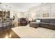 Open floor plan with living room, dining area, and kitchen featuring hardwood floors and neutral decor at 857 Spelman Dr, Indian Land, SC 29707