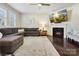 Inviting living room with fireplace, large television, neutral walls, and a comfortable grey sectional sofa at 857 Spelman Dr, Indian Land, SC 29707