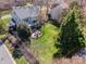 Aerial view of a home with a spacious backyard, patio area, fire pit, and mature trees at 10111 Grimsby Ct, Huntersville, NC 28078