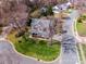 Aerial view of a two-story home with mature trees, a well-manicured lawn, and a welcoming front porch at 10111 Grimsby Ct, Huntersville, NC 28078