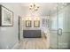 Bright bathroom featuring double vanity, soaking tub, glass enclosed shower, and white shiplap walls at 10111 Grimsby Ct, Huntersville, NC 28078