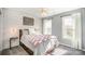 Cozy bedroom with white shiplap accent wall, carpeted floor and two windows at 10111 Grimsby Ct, Huntersville, NC 28078