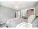 Bedroom featuring carpeted floor, ceiling fan, and mirrored closet at 10111 Grimsby Ct, Huntersville, NC 28078