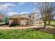 Clubhouse with brick facade, manicured landscaping, and ample parking with playground in background at 10111 Grimsby Ct, Huntersville, NC 28078