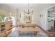 Charming dining room with a farmhouse-style table, bench seating, and natural light at 10111 Grimsby Ct, Huntersville, NC 28078