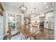 Dining area with views into the kitchen and outdoor living space at 10111 Grimsby Ct, Huntersville, NC 28078