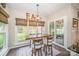 Eat-in kitchen features rustic table with large windows overlooking backyard at 10111 Grimsby Ct, Huntersville, NC 28078