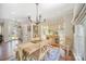 Bright dining room with wood table, chandelier, bay window and hardwood floors at 10111 Grimsby Ct, Huntersville, NC 28078