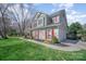 Gray two-story home with red shutters, attached garage, and well-manicured lawn at 10111 Grimsby Ct, Huntersville, NC 28078