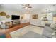 Open-concept living room with hardwood floors, comfortable seating, and a view into the kitchen at 10111 Grimsby Ct, Huntersville, NC 28078