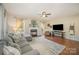 Spacious living room featuring a fireplace, hardwood floors, and comfortable sectional sofa at 10111 Grimsby Ct, Huntersville, NC 28078