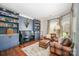 Cozy living room featuring built-in bookshelves, comfortable seating, and hardwood floors at 10111 Grimsby Ct, Huntersville, NC 28078