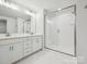 Bright bathroom with double vanity and glass-enclosed shower showcasing white subway tiles at 10117 Mamillion Dr, Huntersville, NC 28078