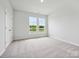 Sun-filled bedroom with plush carpeting and two large windows offering a pleasant view at 10117 Mamillion Dr, Huntersville, NC 28078