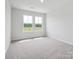 Bright bedroom with neutral carpet and two large windows at 10117 Mamillion Dr, Huntersville, NC 28078