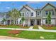 Charming new townhomes with stone accents, well-manicured lawns, and inviting front porches at 10117 Mamillion Dr, Huntersville, NC 28078
