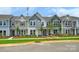 Charming townhome with a well-manicured lawn and colorful exterior at 10117 Mamillion Dr, Huntersville, NC 28078