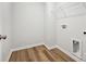 Small laundry room with wood-look flooring, a metal rack, and washer/dryer hookups at 10117 Mamillion Dr, Huntersville, NC 28078