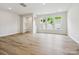 Bright and airy living room with wood-look floors and large windows allowing for natural light at 10117 Mamillion Dr, Huntersville, NC 28078