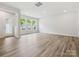 Spacious living room featuring wood-look flooring, recessed lighting, and large windows at 10117 Mamillion Dr, Huntersville, NC 28078