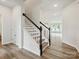 Stylish staircase with modern black and white railings leading to the upper level at 10117 Mamillion Dr, Huntersville, NC 28078