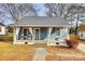 Charming blue house with a wraparound porch and well-manicured lawn at 124 Piedmont St, Rock Hill, SC 29730