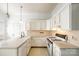 Galley style kitchen with white cabinets and gas stove at 124 Piedmont St, Rock Hill, SC 29730